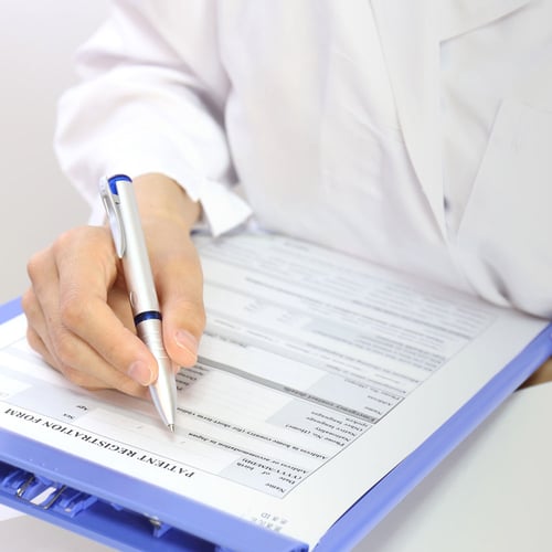 medical personnel filling out ExpressReqs™ form 